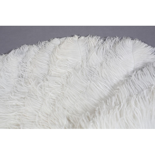 40 - A very large and fluffy white ostrich feather fan, the monture of cream celluloid, the long feathers... 