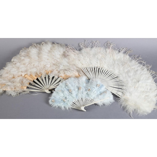 41 - Three feather fans, early 20th century, the first with monture of wood, painted white and silvered, ... 