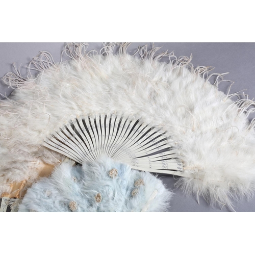 41 - Three feather fans, early 20th century, the first with monture of wood, painted white and silvered, ... 