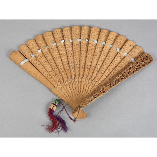 53 - A Chinese carved sandalwood brisé fan, Qing Dynasty, with fourteen inner sticks and two the guards v... 