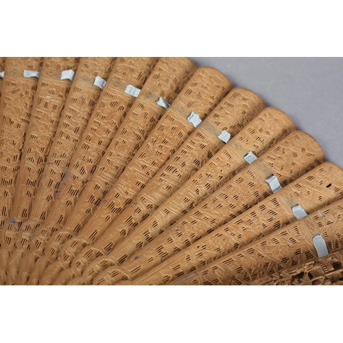 53 - A Chinese carved sandalwood brisé fan, Qing Dynasty, with fourteen inner sticks and two the guards v... 