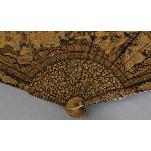 60 - A Chinese lacquer brisé fan, Qing dynasty, nineteen inner sticks and two guards, the black lacquer d... 