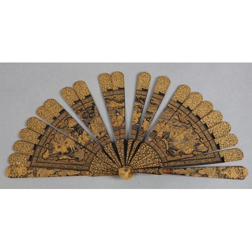 60 - A Chinese lacquer brisé fan, Qing dynasty, nineteen inner sticks and two guards, the black lacquer d... 