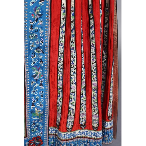 62 - A red Chinese silk skirt, Qing Dynasty, unusually long, cotton waistband, applied with vertical pane... 