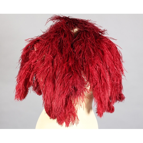 63 - A 1930’s ruby Ostrich feather shoulder cape, elbow length, lined in ruby silk