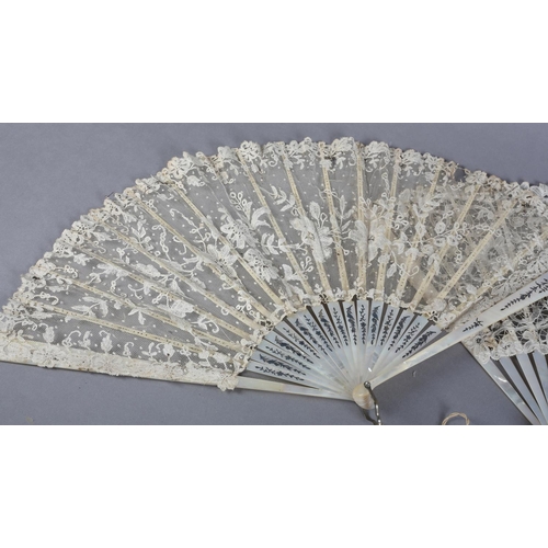 7 - Two white mother of pearl and Belgian lace fans, late 19th century, the first with Bobbin lace leaf,... 