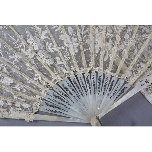 7 - Two white mother of pearl and Belgian lace fans, late 19th century, the first with Bobbin lace leaf,... 