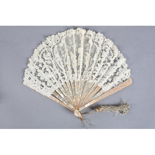 8 - A small Brussels mixed lace fan of fontange form, the leaf mounted on pink mother of pearl, a centra... 