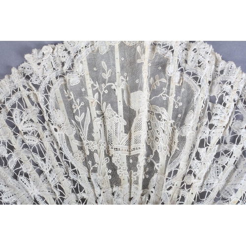 8 - A small Brussels mixed lace fan of fontange form, the leaf mounted on pink mother of pearl, a centra... 