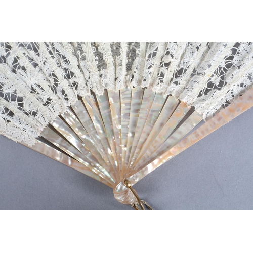 8 - A small Brussels mixed lace fan of fontange form, the leaf mounted on pink mother of pearl, a centra... 