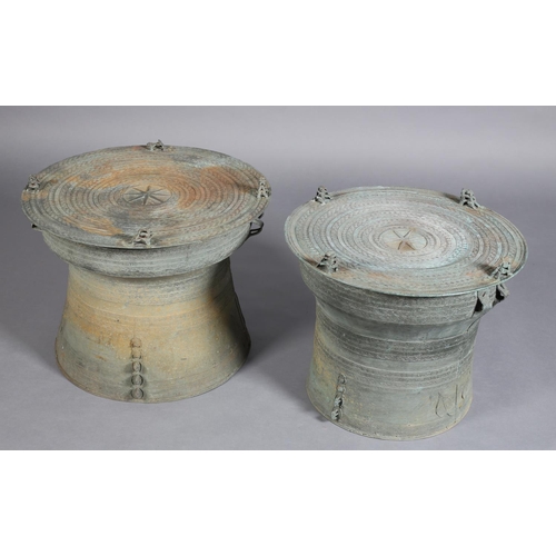 80 - A PAIR OF BURMESE BRONZE RAIN DRUMS, possibly 19th century of graduated size, finely cast, the patin... 