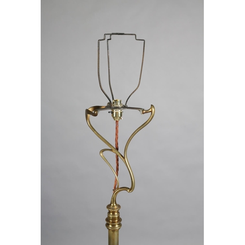 97 - AN ART NOUVEAU BRASS STANDARD LAMP having an open swept basket on a telescopic column and tripod bas... 