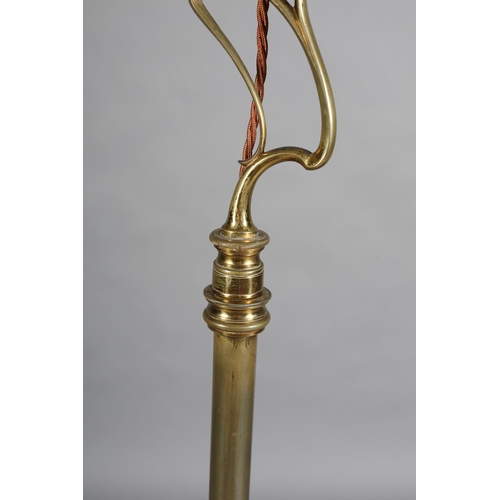 97 - AN ART NOUVEAU BRASS STANDARD LAMP having an open swept basket on a telescopic column and tripod bas... 