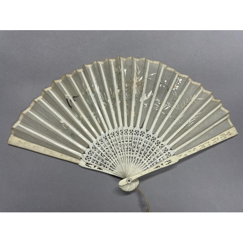 51 - A small Chinese folding fan, Qing Dynasty, the monture of carved bone, the white gauze leaf embroide... 