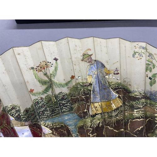 57 - A very unusual possibly 18th century Chinese folding paper fan, the double leaf mounted on wood stic... 