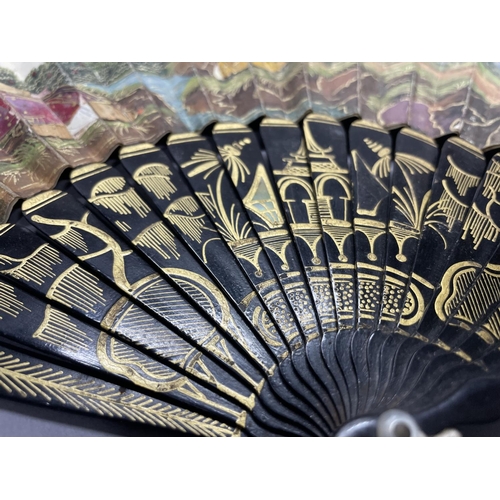 57 - A very unusual possibly 18th century Chinese folding paper fan, the double leaf mounted on wood stic... 