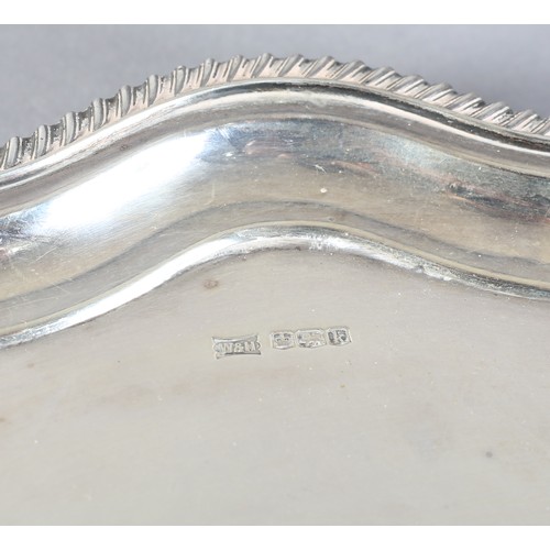 228B - A GEORGE V SILVER TRAY SHEFFIELD 1927 by Walker and Hall, of circular serpentine outline with gadroo... 