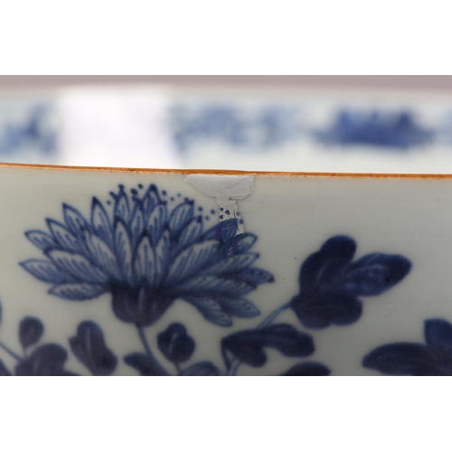 30 - AN 18TH CENTURY CHINESE BLUE AND WHITE BOWL, painted to the exterior with a fort and landscape crane... 