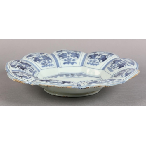 41 - AN 18TH CENTURY DUTCH DELFT LOBED DISH, painted in the chinoiserie manner with an elegant figure and... 