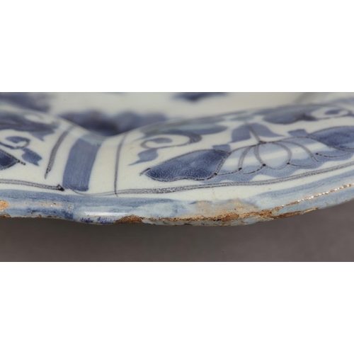 41 - AN 18TH CENTURY DUTCH DELFT LOBED DISH, painted in the chinoiserie manner with an elegant figure and... 