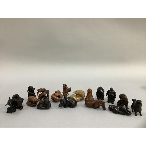 81 - A collection of 17 carved hardwood netsuke and including humanoid, natural, mythological and phallic... 