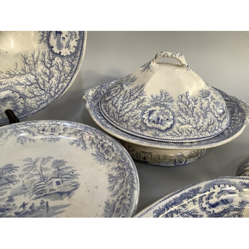 16 - A quantity of blue and white printed dinner ware with figures in a boat beside a cottage within a bo... 