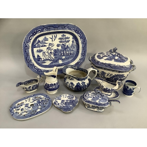 105 - A collection of Victorian and later blue and white willow pattern dinner ware of differing factories... 