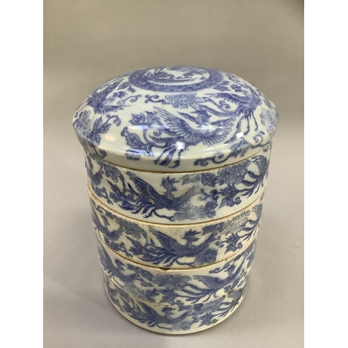 29 - A 19th century Chinese blue and white four stacking rice bowls and cover, painted with ornate birds ... 