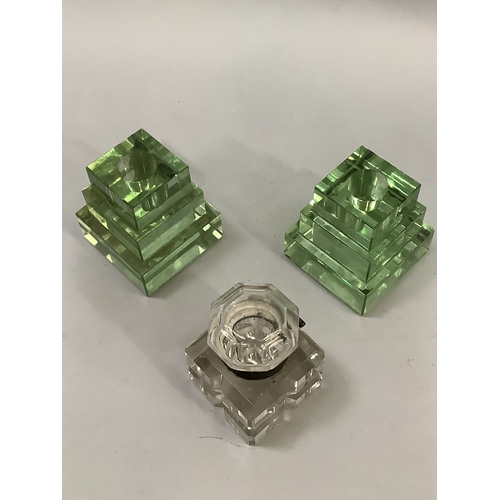 55 - A pair of green glass stepped inkwells together with another inkwell with silver plated mount