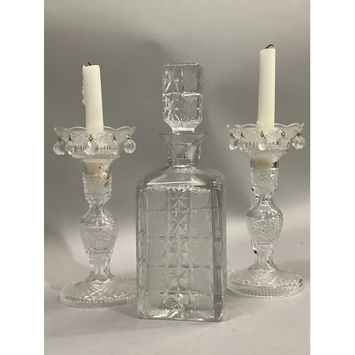 58 - A pair of cut glass candle lustres hung with drops, 21cm high, together with a cut glass spirit deca... 