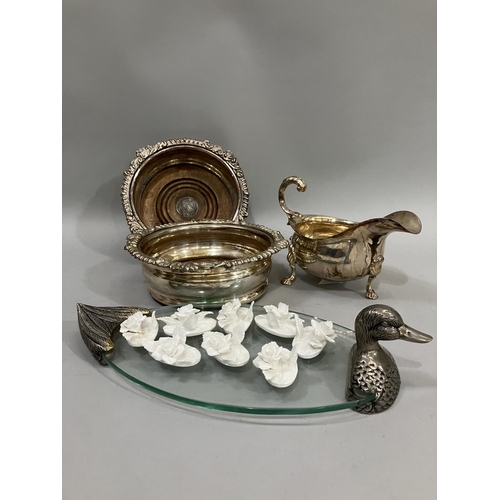 68 - A pair of silver plated wine coasters with gadroon rims, a saucer boat on three pad feet, a pewter a... 