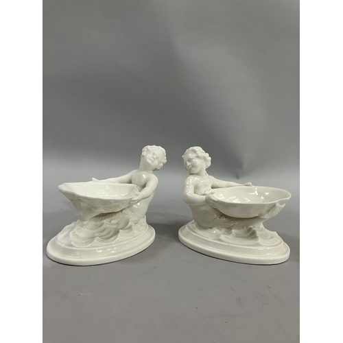 69 - A pair of Royal Worcester salts in the form of mermaids holding a shell, green printed stamp no. 349... 