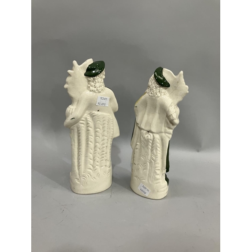 71 - A pair of late 19th/early 20th century Stafforshire gardening figures attired in green, the man with... 