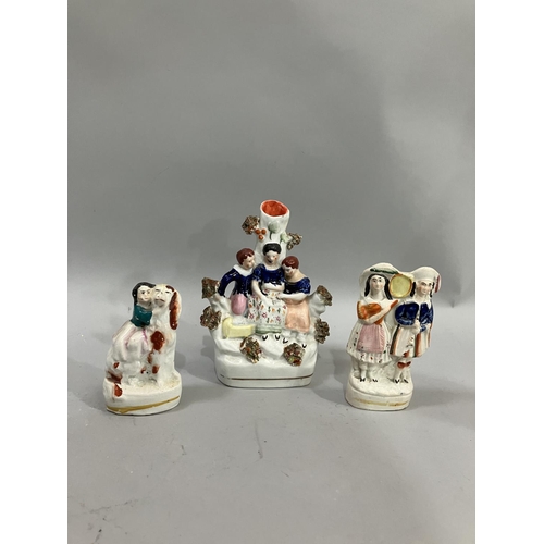 72 - Three small 19th century Staffordshire groups, a Scottish piper and companion with tamborine, 13cm h... 