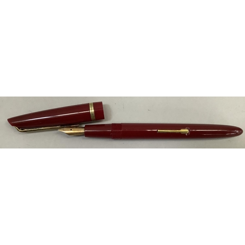 9 - A vintage Waterman fountain pen, maroon case with gilt metal clip and band, stamped: Watermans L2 14... 