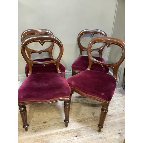 485 - A set of four mahogany balloon back dining chairs, wine coloured upholstery and on turned and lobed ... 