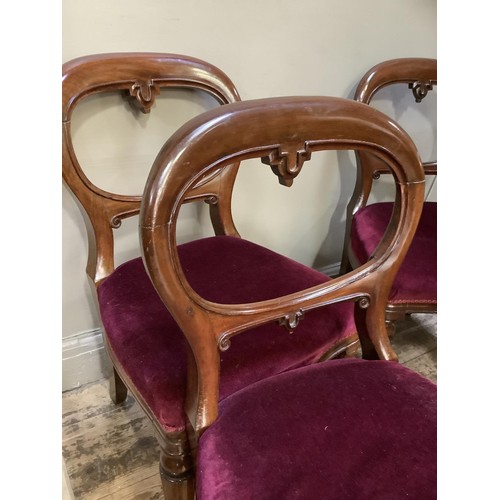 485 - A set of four mahogany balloon back dining chairs, wine coloured upholstery and on turned and lobed ... 