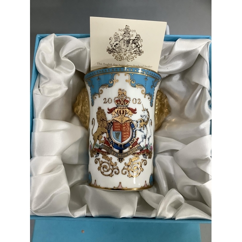 13 - An English fine bone china lion head beaker, especially commissioned by the Royal Commission to comm... 