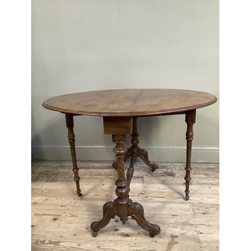 481 - A Victorian figured walnut oval gate legged table inlaid in satin wood and ebony with stringing and ... 