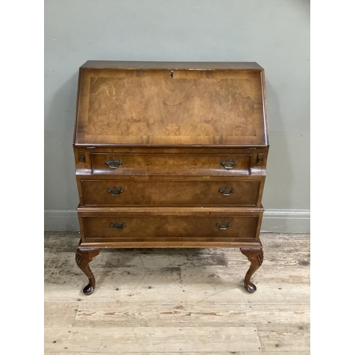 483 - A figured walnut bureau having a fall front with fitted interior over three long graduated drawers a... 