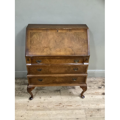 483 - A figured walnut bureau having a fall front with fitted interior over three long graduated drawers a... 