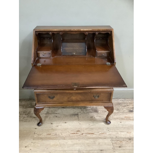 483 - A figured walnut bureau having a fall front with fitted interior over three long graduated drawers a... 