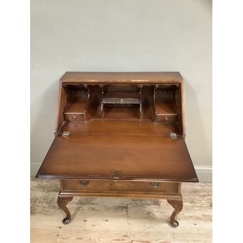 483 - A figured walnut bureau having a fall front with fitted interior over three long graduated drawers a... 