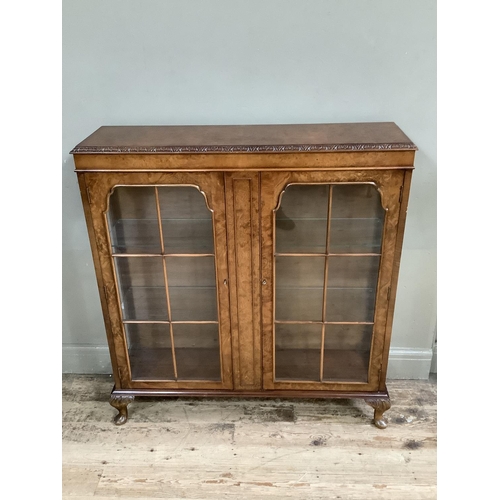 483 - A figured walnut bureau having a fall front with fitted interior over three long graduated drawers a... 