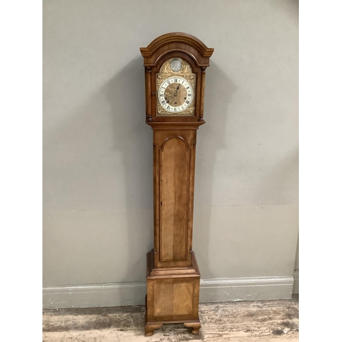 488B - A mahogany and walnut grandmother clock having an arched hood with pilasters, gilt dial with silvere... 