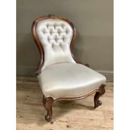 498 - Victorian rosewood nursing chair having an encircling frame with leaf cresting, serpentine seat, cab... 