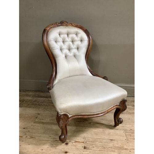 498 - Victorian rosewood nursing chair having an encircling frame with leaf cresting, serpentine seat, cab... 