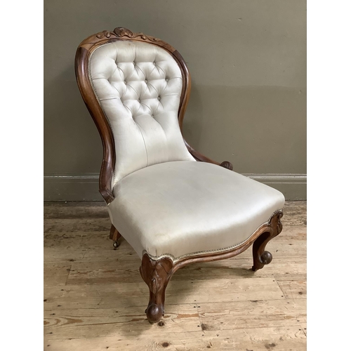 498 - Victorian rosewood nursing chair having an encircling frame with leaf cresting, serpentine seat, cab... 