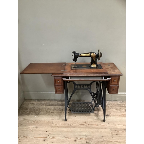 499 - A Jones sewing machine in table cabinet with small drawers, cast iron legs and treadle 86cm wide x 4... 