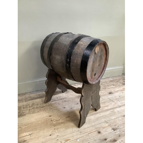 500 - An iron bound barrel on stand (no spigot), height of barrel 54cm x 35cm diameter